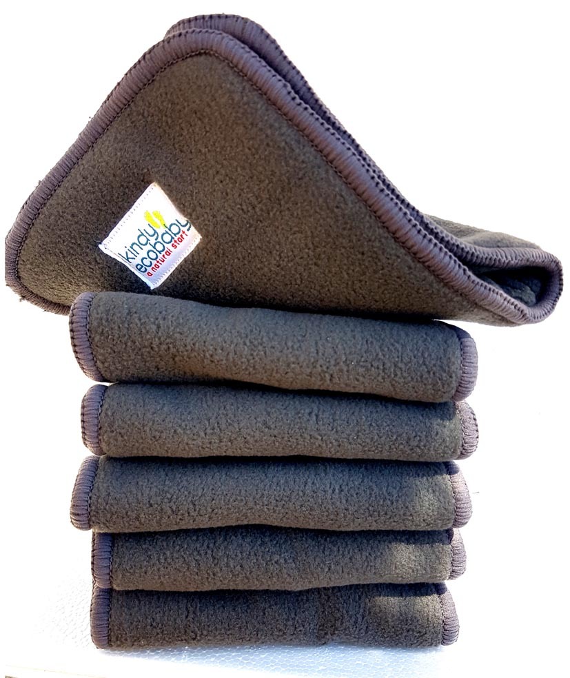 Charcoal Bamboo Nappy Inserts in a pile with the Kindy Ecobaby Label showing on the top one which is curled upwards