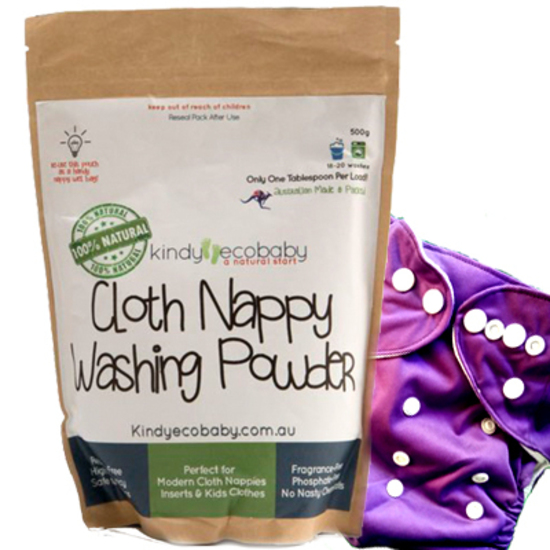A pack of Kindy Ecobaby cloth nappy washing powder next to a purple nappy and against a white background