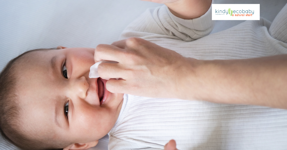 Baby having face cleaned with a wet wipe