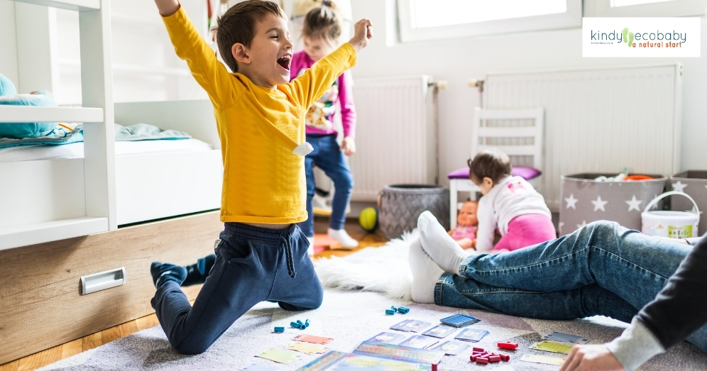 A warm, inviting living room scene where siblings of various ages are engaged in a collaborative board game, with parents participating or observing nearby, illustrating a harmonious family environment that promotes strong sibling relationships and teamwork.